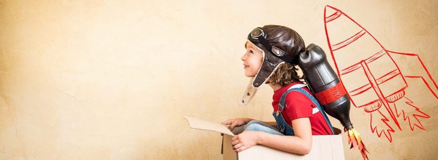 Kid with jet pack. Child playing at home. Success, leader and winner concept